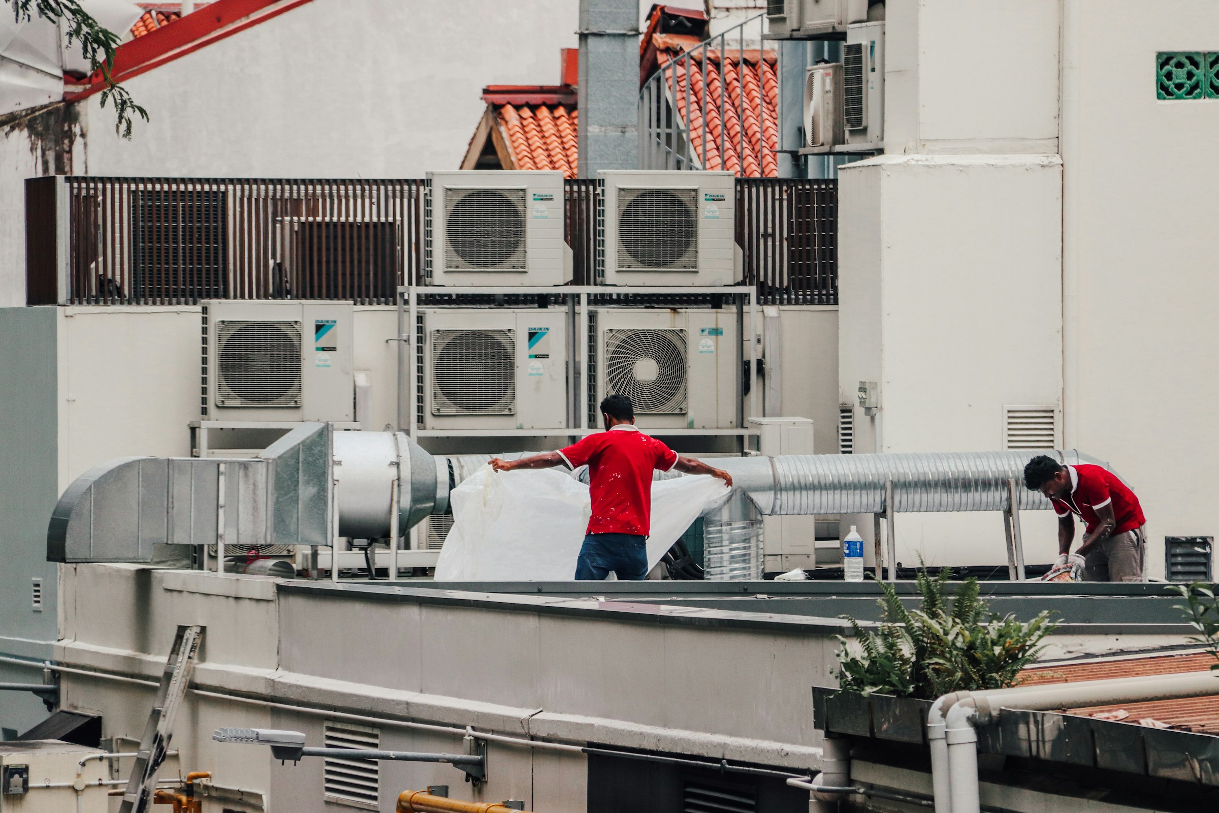 HVAC technicians servicing rooftop units
